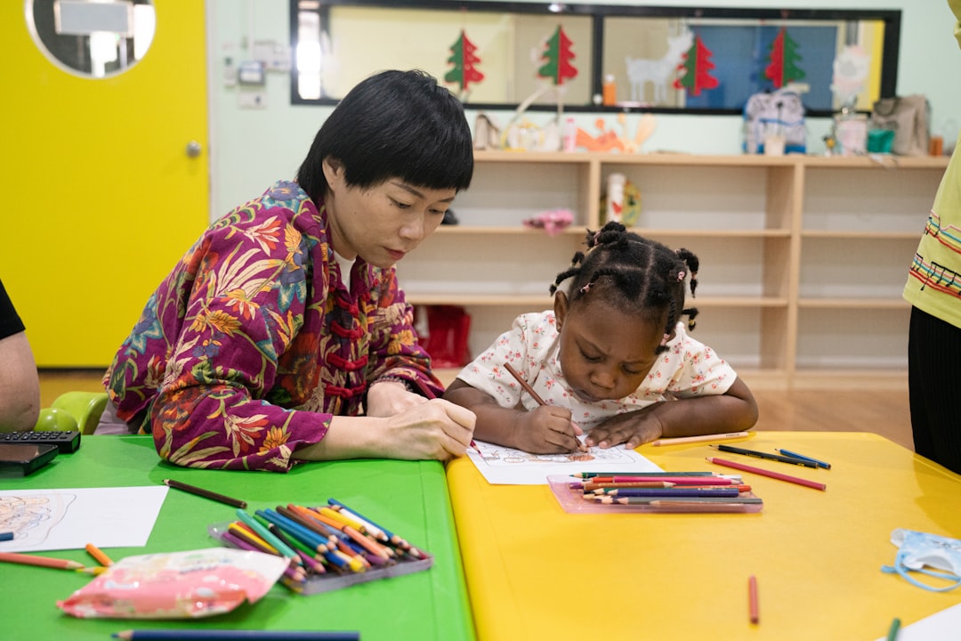 Teacher guiding children in art activity
